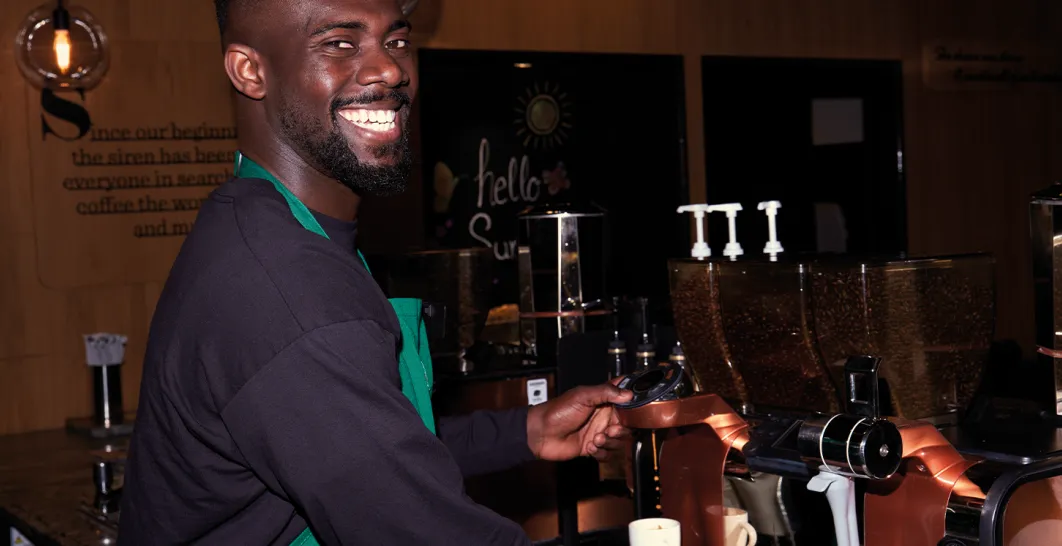 A Barista at a coffee machine